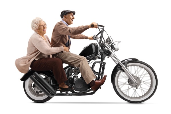 Senior,Man,And,Woman,Riding,On,A,Custom,Motorbike,Isolated